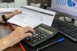 Calculator and financial documents on a desk