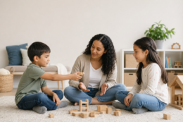 Two school-age siblings calmly reconnecting with a parent after resolving a conflict