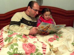 A parent reading a bedtime story with a school-age child