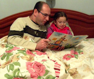 A parent reading a bedtime story with a school-age child