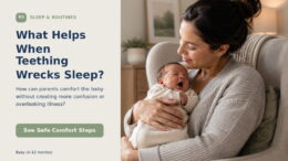 A parent cradling a yawning young baby in a softly lit room during a quiet night routine.