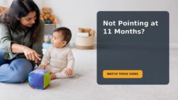 A parent and an 11-month-old baby sharing attention with a toy during floor play