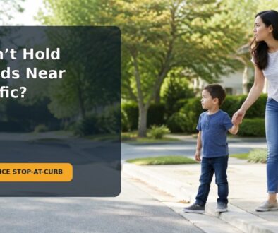 A parent holds a preschooler’s hand while they stop together at a curb near a quiet street