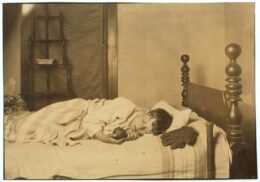 School-age child sleeping in bed while adjusting to an earlier school schedule