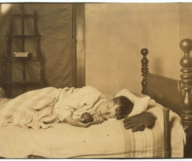 School-age child sleeping in bed while adjusting to an earlier school schedule