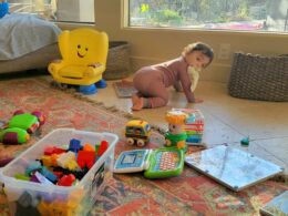 Toddler playing at home while a parent stays nearby, illustrating calm support during the toddler years