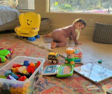 Toddler playing at home while a parent stays nearby, illustrating calm support during the toddler years