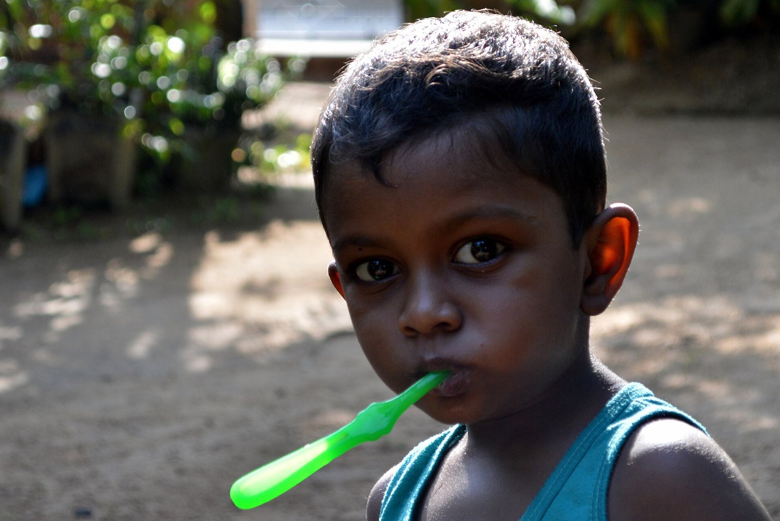 A young child brushes their teeth in the morning.
