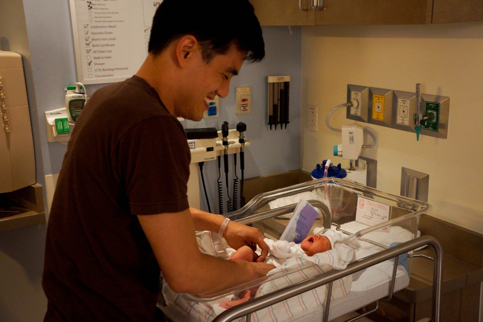 A father gently cares for a newborn, used as an editorial illustration for a parent guide about helping a baby through brief separations.