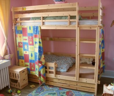 A tidy wooden bunk bed in a quiet bedroom, illustrating a child sleep-health article.