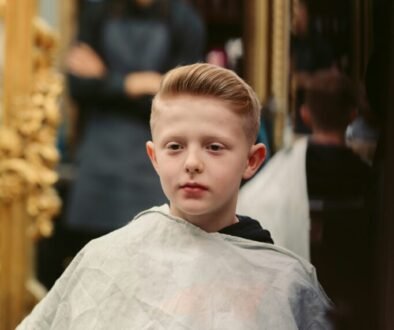 A young child receiving a haircut at a barber shop.