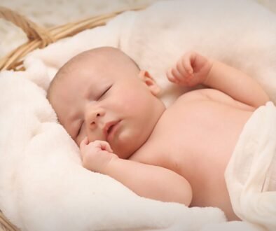 A newborn sleeping peacefully in a basket, shown as a general newborn-care image.