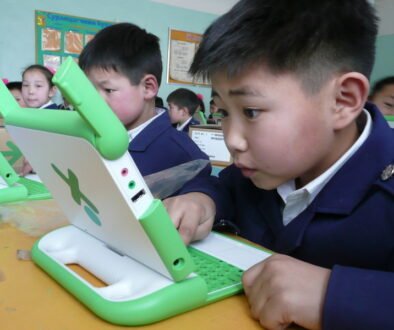 A young person using a small laptop, illustrating a parent and teen discussion about using an AI tool responsibly.