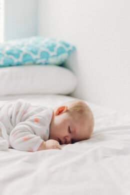 A baby sleeping peacefully in a crib