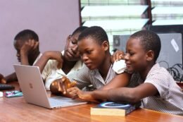 Students using a laptop together, used as a CC0 editorial illustration for a school Chromebook eye-strain check.
