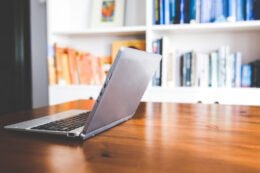 A laptop, notebook and workspace used as an editorial illustration for a teen’s first-job weekly schedule.