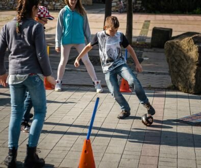 Children play sport outdoors; a Creative Commons editorial image for a guide about a tween deciding whether to leave an activity midseason.
