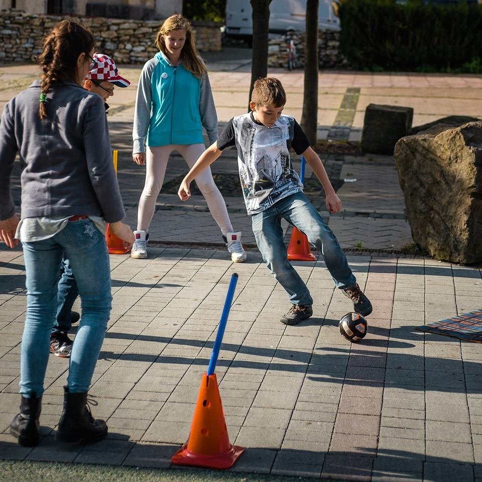 Children play sport outdoors; a Creative Commons editorial image for a guide about a tween deciding whether to leave an activity midseason.