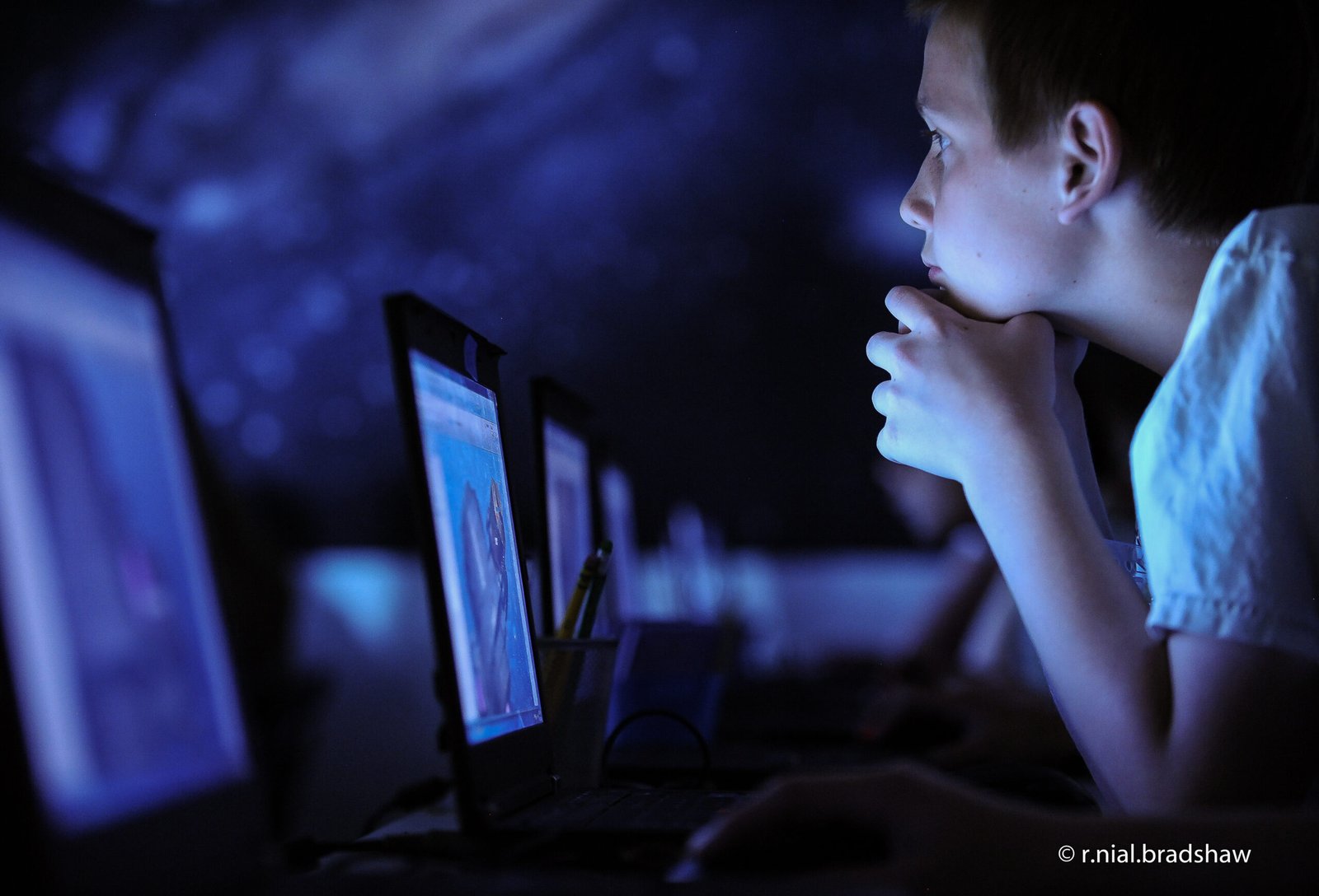 A child using a computer as a reminder that a predictable video call can support connection when a parent travels for work.