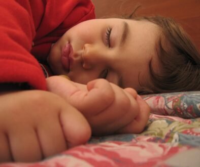 A child sleeping peacefully in bed.